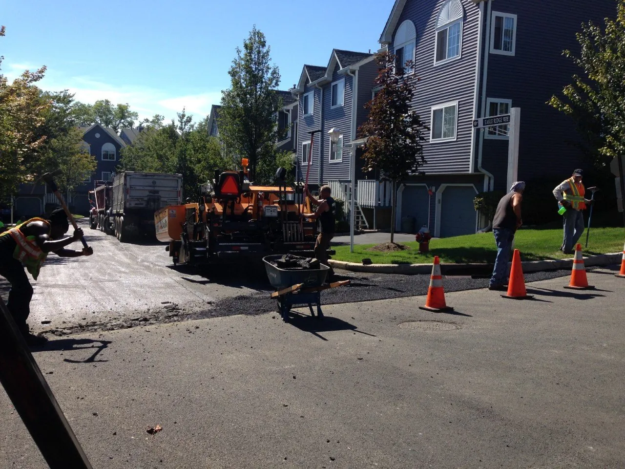 The crew paving a new driveway at a townhome community