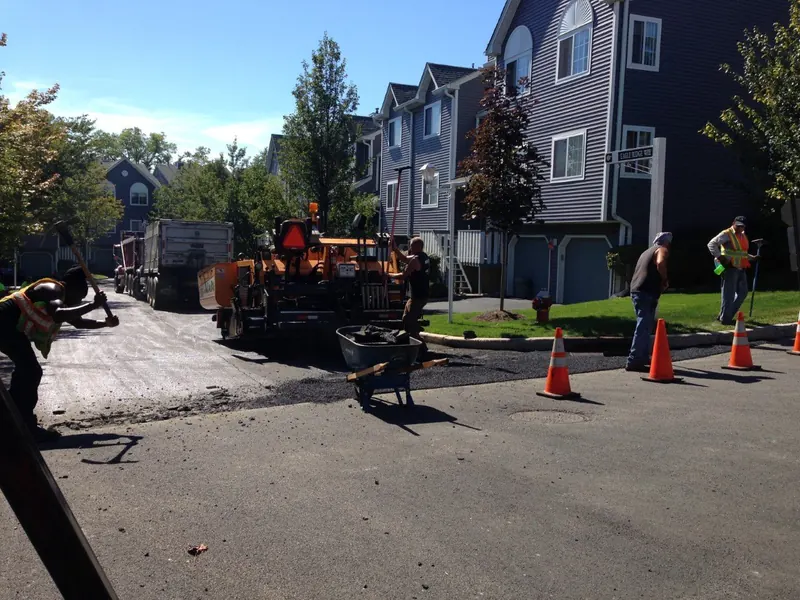 The crew paving a new driveway at a townhome community