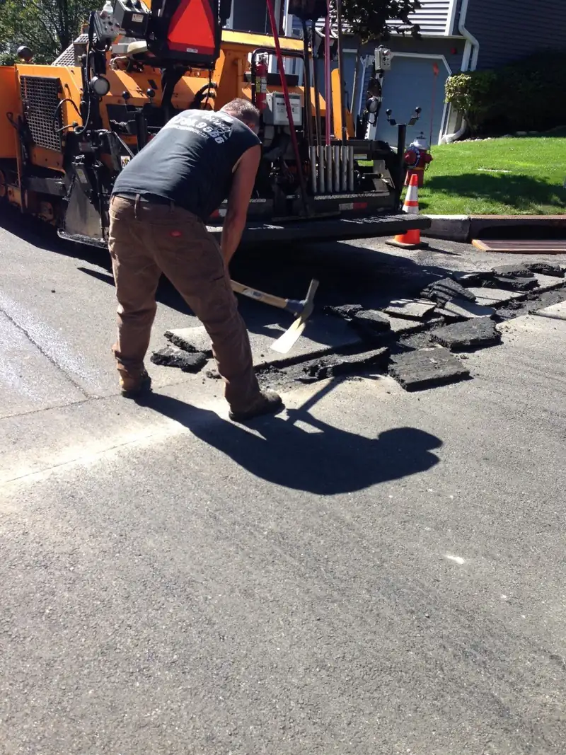 Breaking out old asphalt before a new driveway goes down